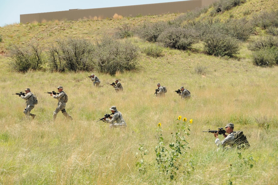 U.S. Airmen with the 161st Security Forces Squadron, Arizona Air National Guard, receive land navigation training from soldiers assigned to the 856th Military Police Company, at the Prescott Valley SWAT training grounds, Prescott Valley, Ariz., Aug. 3, 2013. The Airmen are preparing for an upcoming deployment with training focused on weapons firing, building entry and self-aid buddy care. (U.S. Air National Guard photo by Tech. Sgt. Susan Gladstein/Released)