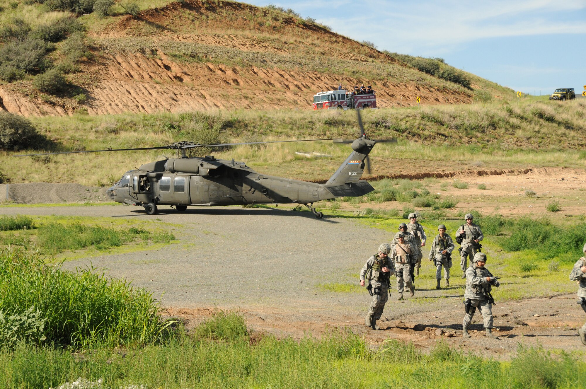 U.S. Airmen with the 161st Security Forces Squadron, Arizona Air National Guard, are dropped off at the Prescott Valley SWAT training grounds, Prescott Valley, Ariz., Aug. 3, 2013. The Airmen are preparing for an upcoming deployment with training focused on weapons firing, building entry and self-aid buddy care. (U.S. Air National Guard photo by Tech. Sgt. Susan Gladstein/Released)