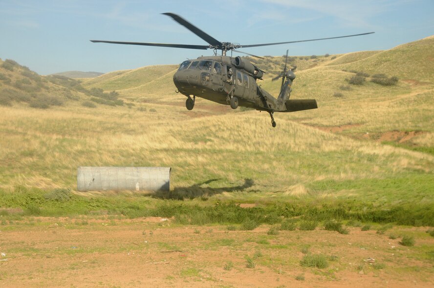 U.S. Airmen with the 161st Security Forces Squadron, Arizona Air National Guard traveled to Prescott Valley, Ariz., Aug. 3-4, 2013, via two UH-60 Blackhawk helicopters provided by the Arizona Army National Guard.  The Airmen are preparing for an upcoming deployment with training focused on weapons firing, building entry and self-aid buddy care. (U.S. Air National Guard photo by Tech. Sgt. Susan Gladstein/Released)