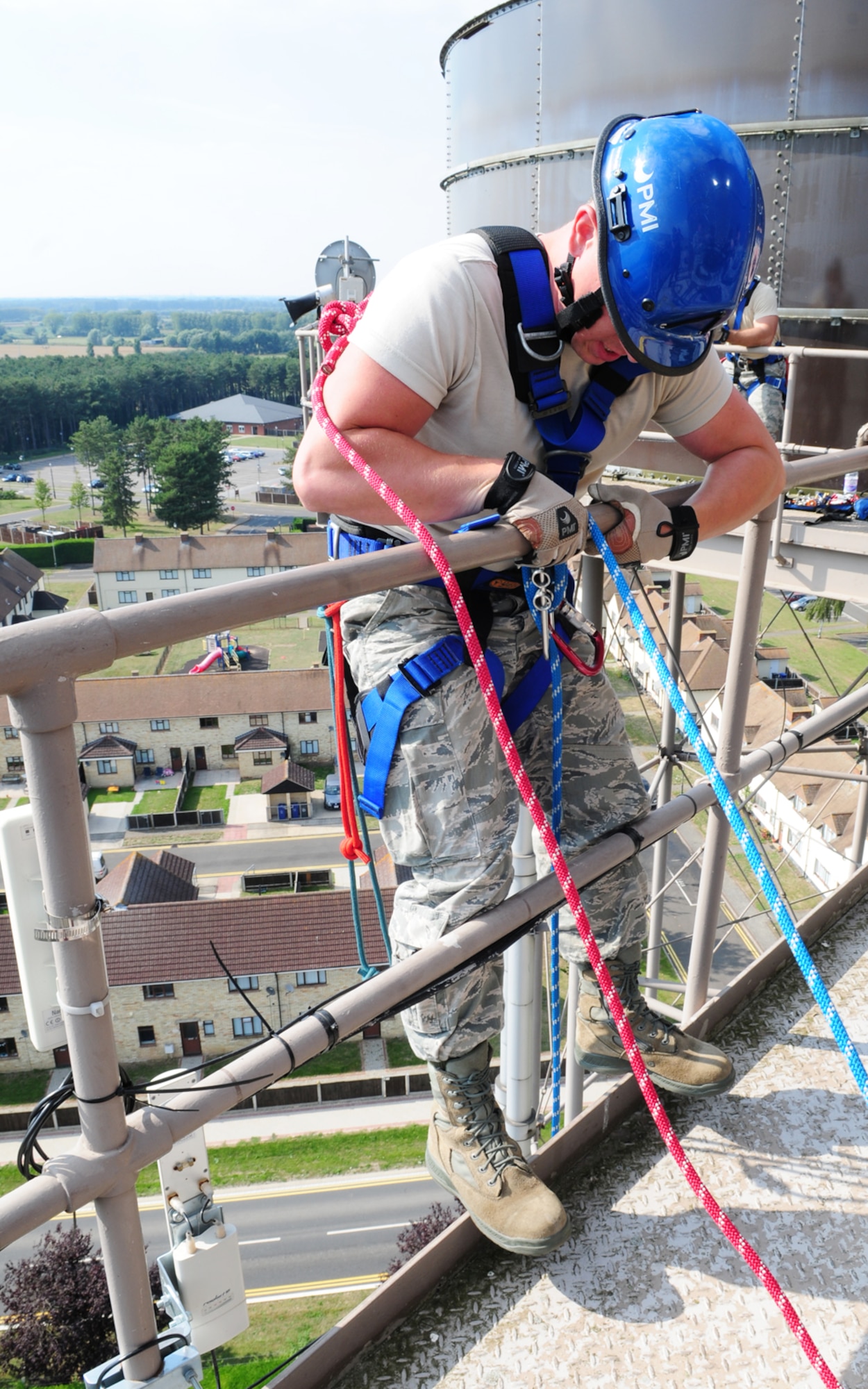 U.S. Air Force Airman 1st Class Jacob Dietmeyer, 100th Civil Engineer Squadron Fire Department firefighter from Gurnee, Ill., performs a final safety check on his belay line before descending almost 120 feet from a water tower Sept. 4, 2013, during technical rope rescue training on RAF Mildenhall, England. Instructors from the 435th Construction and Training Squadron, Ramstein Air Base, Germany, spent time at the 100th CES Fire Department training firefighters on a variety of rescue techniques and scenarios including incident management training, mechanical advantage systems, and low and high angle rescue. This training is vital to keep first responders proficient in procedures, in the event a rescue requires such skills. (U.S. Air Force photo by Karen Abeyasekere/Released)