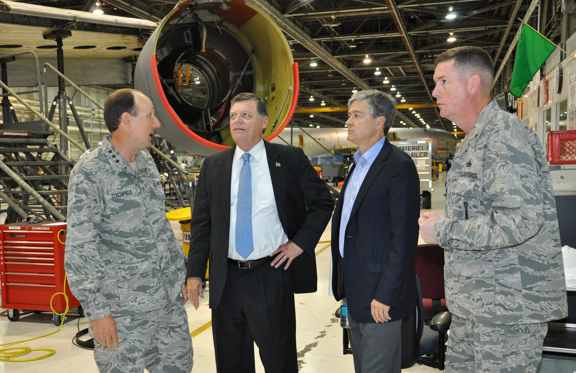 Lt. Gen. Bruce Litchfield, Air Force Sustainment Center commander, left, and Brig. Gen. Donald Kirkland, Oklahoma City Air Logistics Complex commander, right, brief U.S. Representative Tom Cole, 4th District, Oklahoma, center left, and CNBCs chief Washington correspondent John Harwood, on the KC-135 programmed depot maintenance line at the OC-ALC. The congressman visited Tinker Sept. 3, toured areas of the maintenance complex and met with the installation?s senior leaders. CNBC is following the congressman?s visit to his home district for a special report. (U.S. Air Force photo by Darren D. Heusel) 