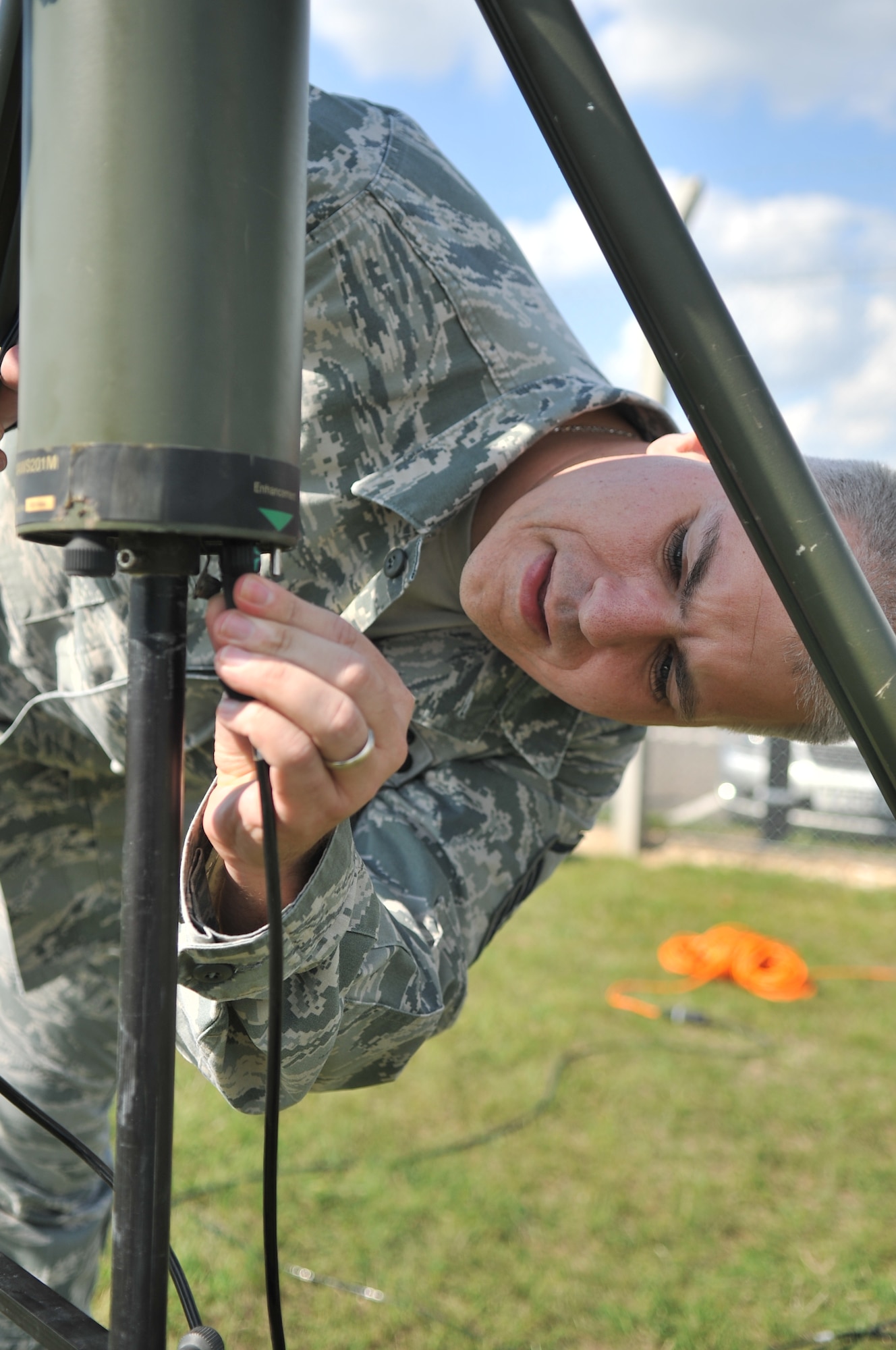 U.S. Air Force Master Sgt. Keith Bachand, 100th Operations Support Squadron weather forecaster from Canterbury, Conn., plugs a backup tactical meteorological observing sensor into a power source during a routine training exercise Aug. 26, 2013, on RAF Mildenhall, England. Bachand must pay attention to detail to ensure the equipment functions properly in the event that the main sensor stops working. The readings from the sensor are used by air traffic controllers to safely direct aircraft. (U.S. Air Force photo by Airman 1st Class Kyla Gifford/Released)