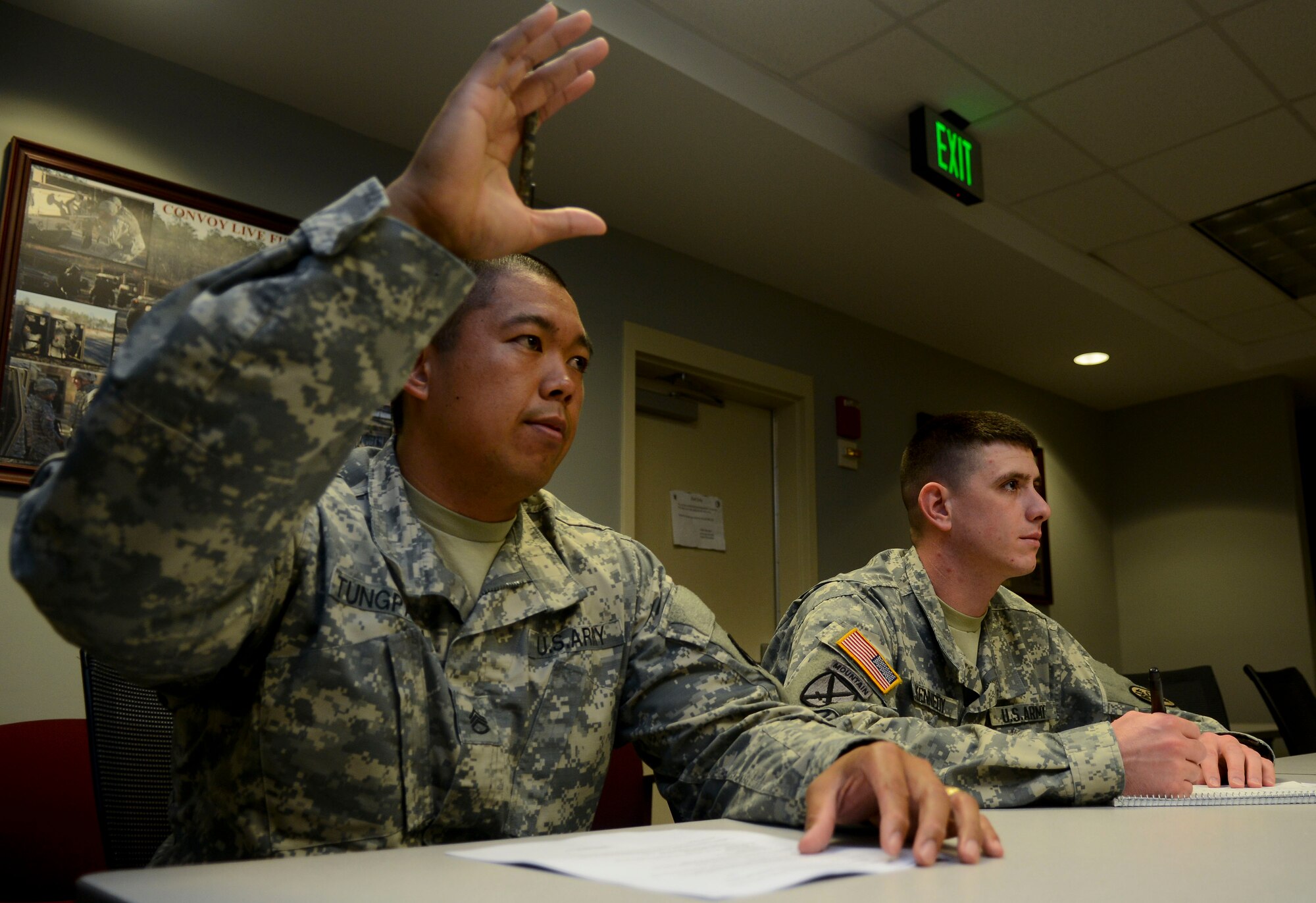 U.S. Army Staff Sgt. Frank Tungpalan, 93rd Signal Bde. information systems operator, raises his hand to answer a question during a professional development class at Fort Eustis, Va., Aug. 7, 2013. Tungpalan believes fellow Soldiers should enjoy their time in the service and learn to live the military lifestyle. (U.S. Air Force photo by Airman 1st Class Austin Harvill/Released)