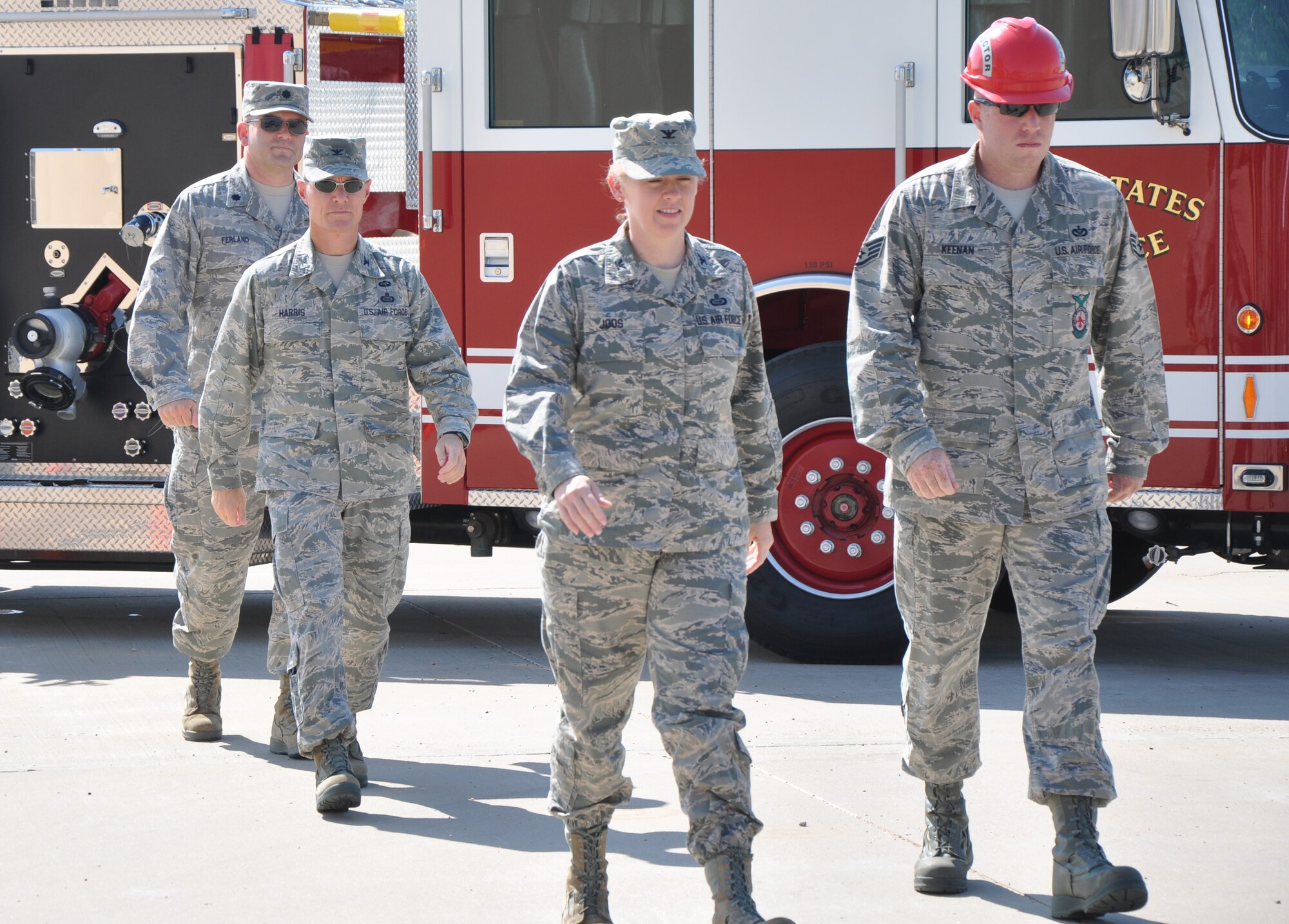 GOODFELLOW AIR FORCE BASE, Texas – The official party arrives at the 312th Training Squadron new firefighter trainer dedication via fire truck Aug. 30. Col. Kimberlee Joos, 17th Training Wing Commander, and Col. Brendan Harris, 17th Training Group Commander, participated in the event by donning firefighter protective gear and breaking down a door. (U.S. Air Force photo/ Airman 1st Class Joshua Edwards)