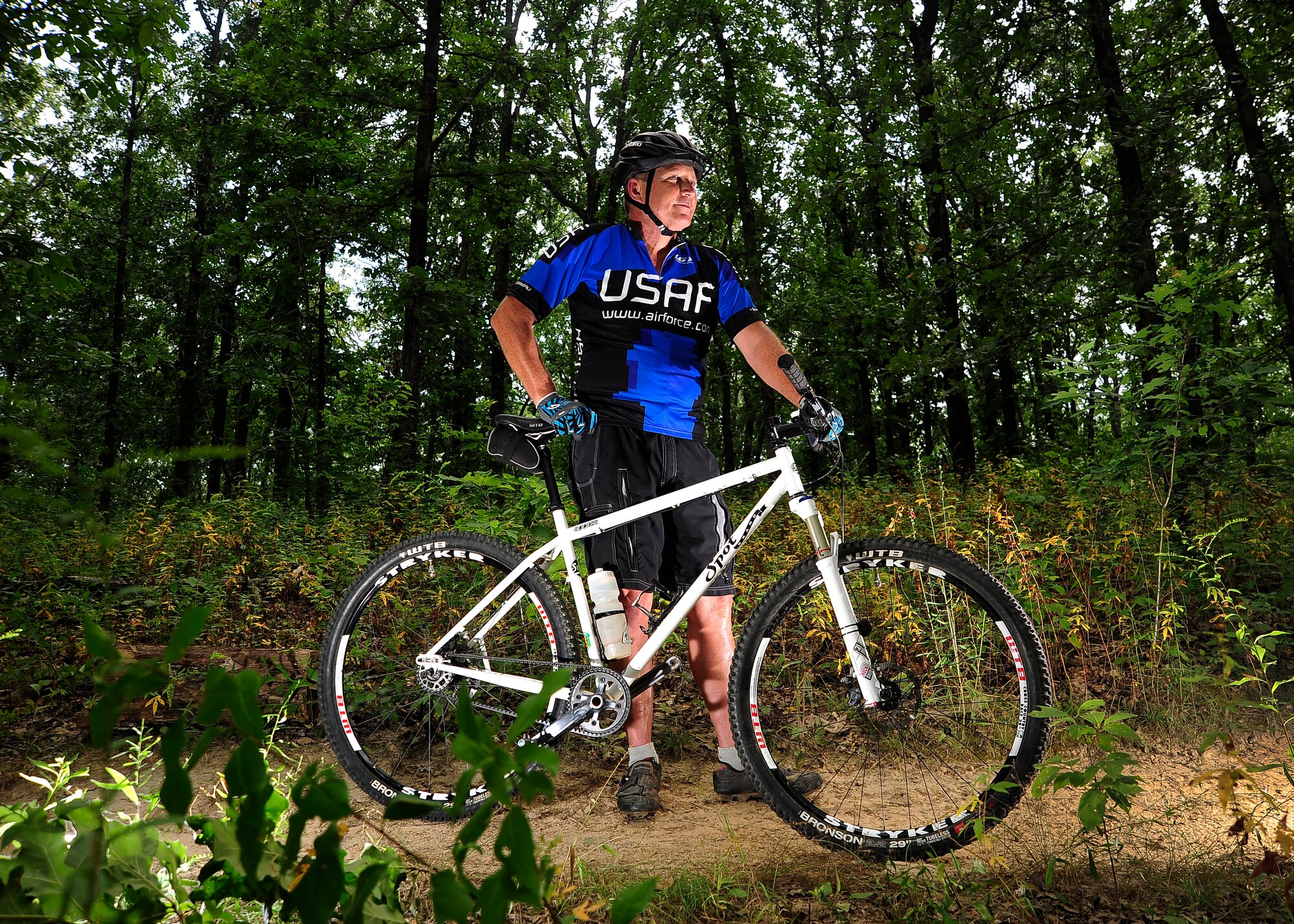 U.S. Air Force Chief Master Sgt. Leroy Cooper, chief controller for the 509th Operations Support Squadron, takes a break during a ride through Knob Noster State Park, Mo., Aug. 22, 2013. While undergoing proton beam therapy for prostate cancer, Cooper used cycling as a way to mentally deal with his situation. Throughout treatment, he accrued more than 1,100 miles and just one week after being declared cancer-free, rode in the world’s oldest, largest and longest bicycle touring event. (U.S. Air Force photo by Staff Sgt. Brigitte N. Brantley/Released)