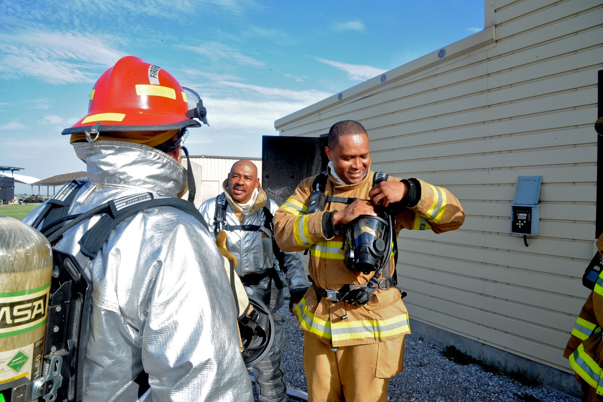 Col. Christopher Daniels, the 71st Mission Support Group commander, talks with firefighters after a training exercise Aug. 29 at Vance Air Force Base, Okla. Daniels took part in the exercise to gain a better understanding of what the men and women of the Vance Fire Department do. (U.S. Air Force photo/ Senior Airman Frank Casciotta)