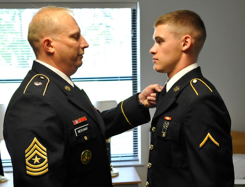 U.S. Army Command Sgt. Maj. Russell Merchant, 1-222nd Aviation Regiment, 1st Battalion command sergeant major, inspects the uniform of Pvt. Steven West, 1-222nd Avn. Rgt. UH-60 Blackhawk crew chief student, at Fort Eustis, Va., Aug. 30, 2013. During down time students have access to a computer cafe and common rooms complete with pool tables and ping-pong tables. (U.S. Air Force photo by Staff Sgt. Wesley Farnsworth/Released)