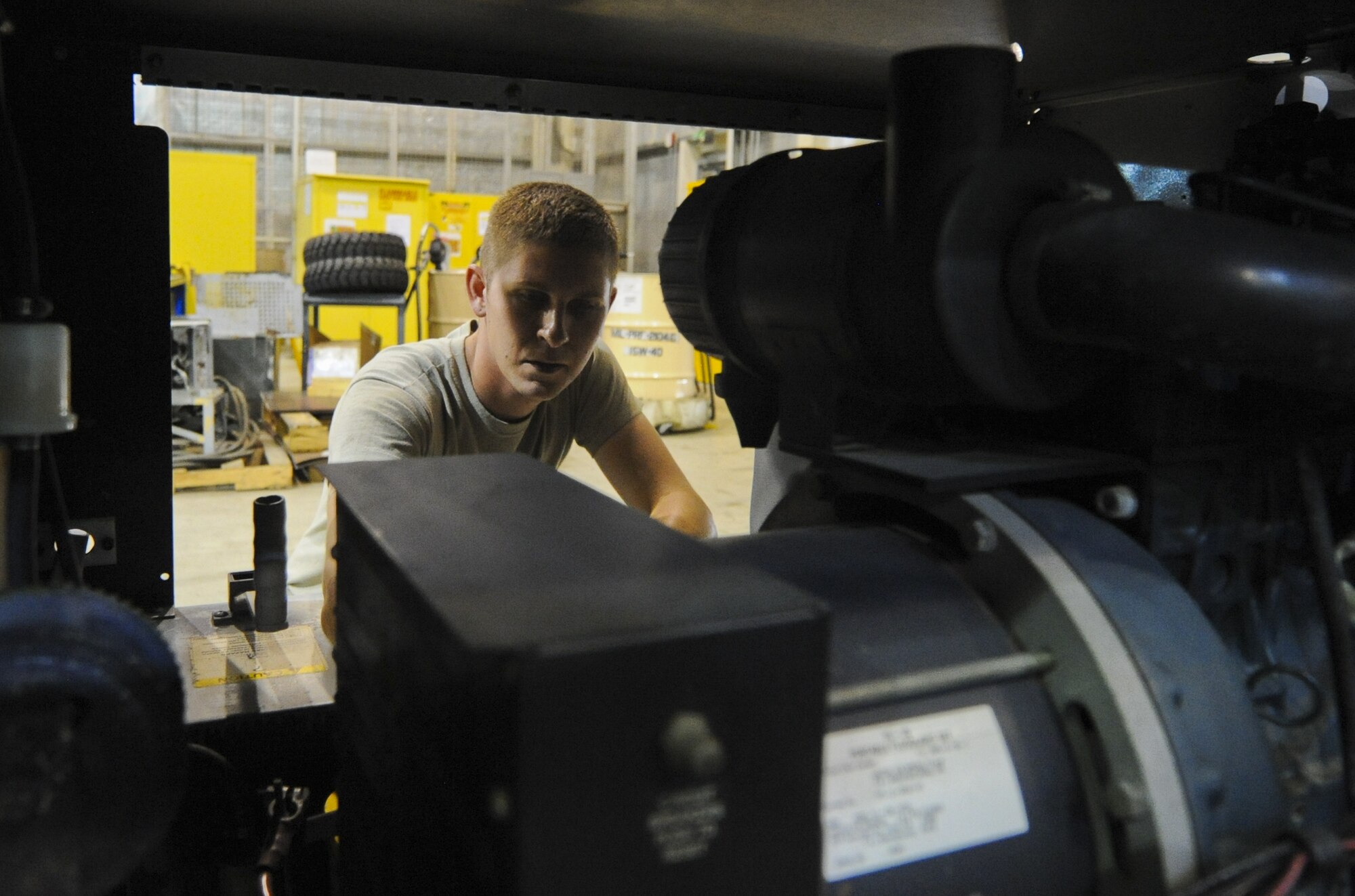 U.S. Air Force Staff Sgt. Kyle Anderson, 380th Expeditonary Maintenance Squadron aerospace ground equipment craftsman, inspects a flood light used on the flightline at an undisclosed location in Southwest Asia Sept. 2, 2013. As the lead on many projects that come into the 380th EMXS AGE section, Anderson is responsible for certifying maintenance done and to return equipment back to into service. Anderson calls Crystal Lake, Ill., home and is deployed from Tinker Air Force Base, Okla. (U.S. Air Force photo by Staff Sgt. Jacob Morgan) 