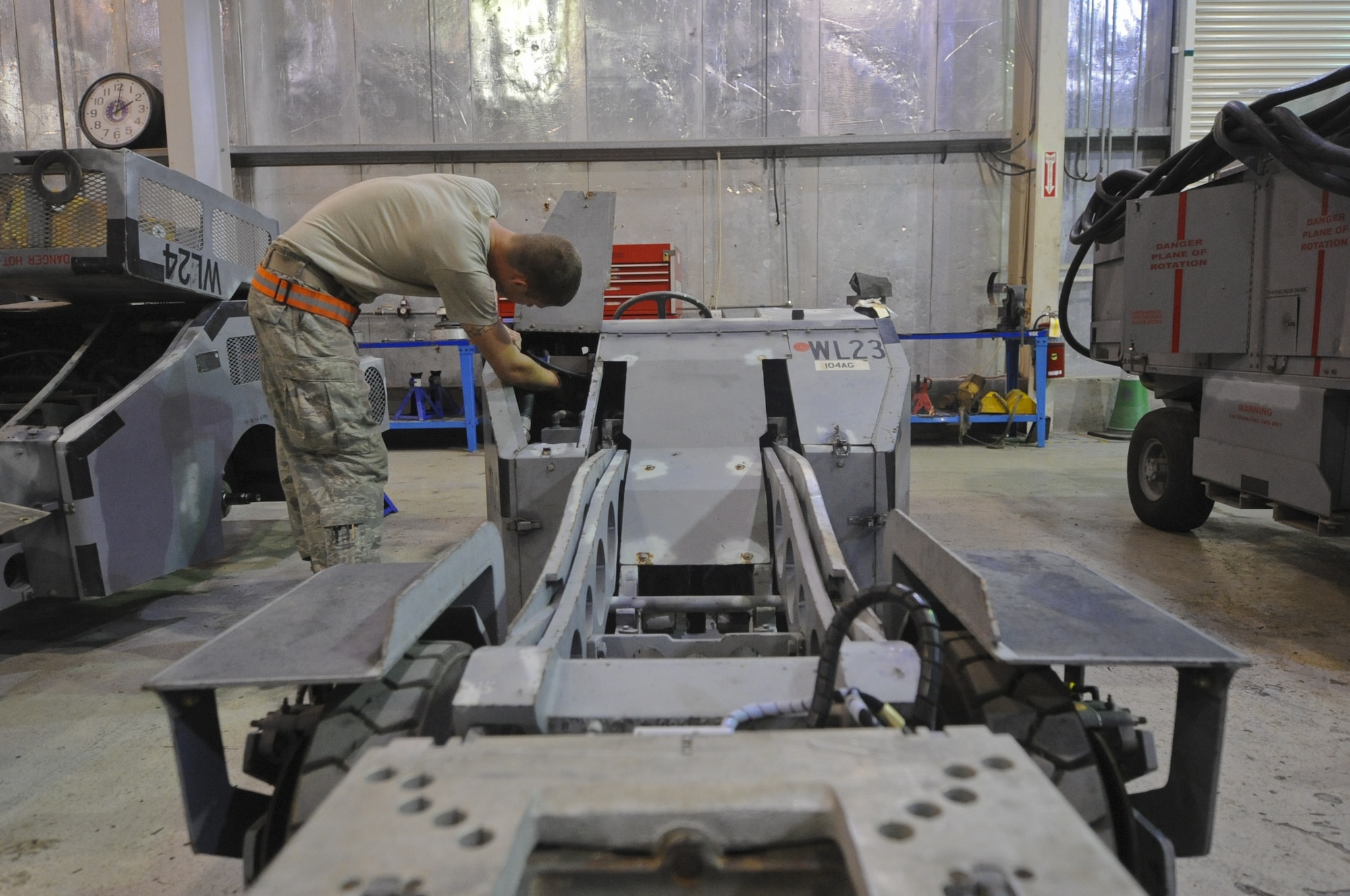 U.S. Air Force Staff Sgt. Kyle Anderson, 380th Expeditonary Maintenance Squadron aerospace ground equipment craftsman, inspects a MJ-1 bomb lift used on the flightline at an undisclosed location in Southwest Asia Sept. 2, 2013. As the lead on many projects that come into the 380th EMXS AGE section, Anderson is responsible for certifying maintenance done and to return equipment back to into service. Anderson calls Crystal Lake, Ill., home and is deployed from Tinker Air Force Base, Okla. (U.S. Air Force photo by Staff Sgt. Jacob Morgan) 