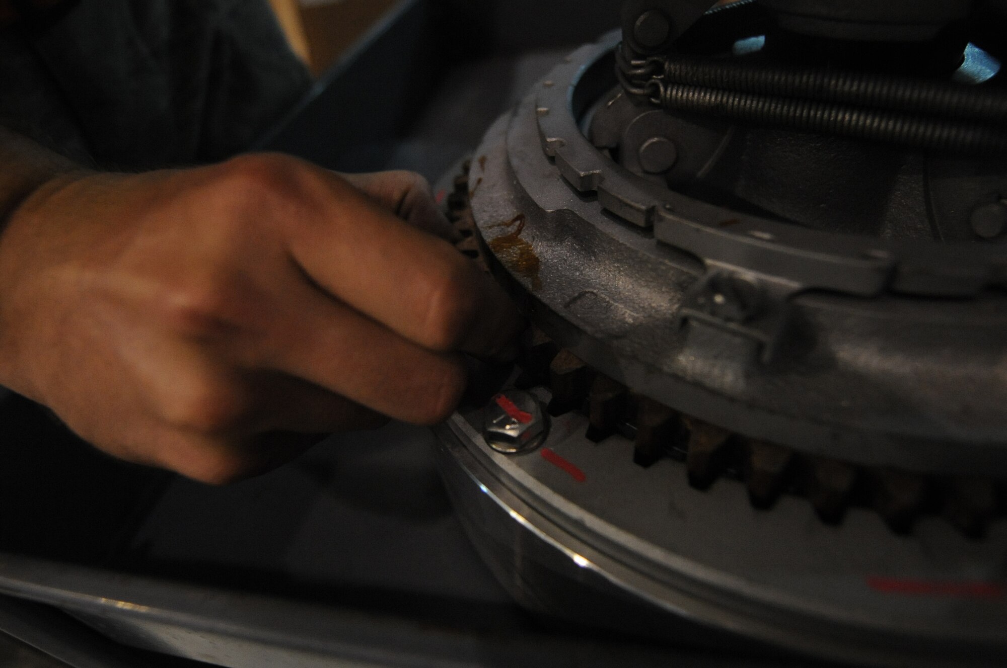 U.S. Air Force Staff Sgt. Kyle Anderson, 380th Expeditonary Maintenance Squadron aerospace ground equipment craftsman, fits the pads of a clutch for an air conditioner used on the flightline at an undisclosed location in Southwest Asia Sept. 2, 2013. The air conditioner is used when aircraft are on the ground to keep electronic equipment cool. Each new clutch is inspected for good condition and installation before being used. Anderson calls Crystal Lake, Ill., home and is deployed from Tinker Air Force Base, Okla. (U.S. Air Force photo by Staff Sgt. Jacob Morgan)