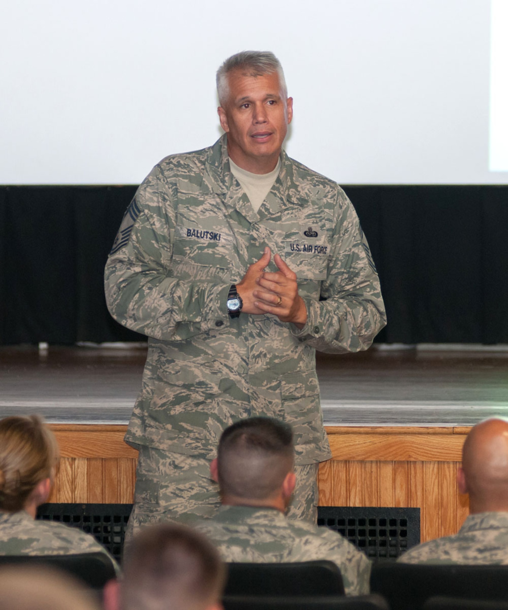 HANSCOM AIR FORCE BASE, Mass. -- Chief Master Sgt. Mitchell Balutski, the installation senior enlisted advisor, speaks to members of the enlisted force Sept. 4 at the base theater during an enlisted call. Balutski used the session to speak with enlisted personnel about the change in uniform policy which takes effect Sept. 9, the upcoming Air Force Ball, fiscal year closeout and tuition assistance changes. (U.S. Air Force photo by Rick Berry)