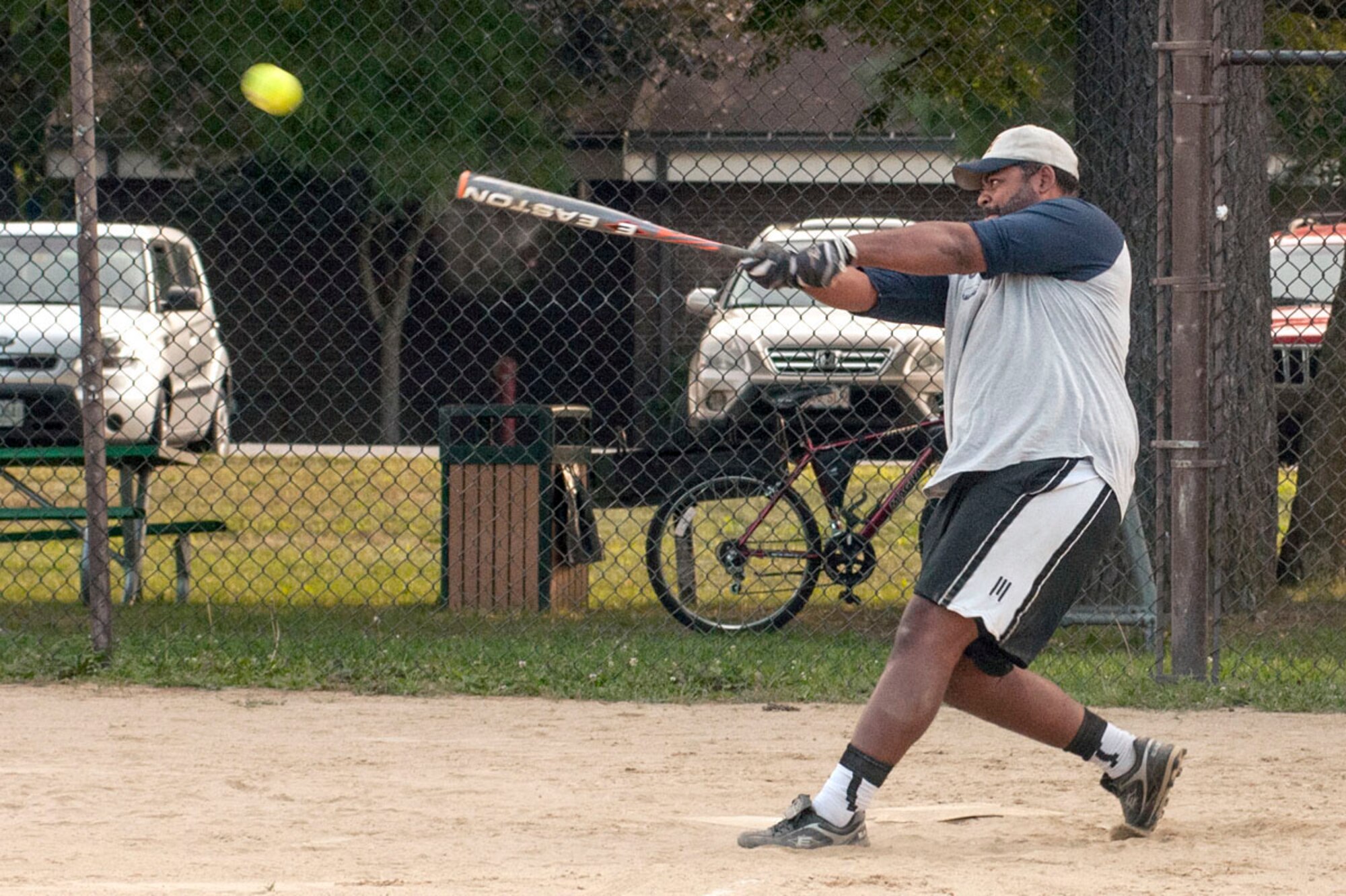 HANSCOM AIR FORCE BASE, Mass. -- Rick Berry swings hard and drives the ball for a hit during a semi-final softball playoff game for the recreational softball league on base Aug. 29. Both the intramural and recreation softball leagues are finishing up the playoffs this month. (Courtesy photo)