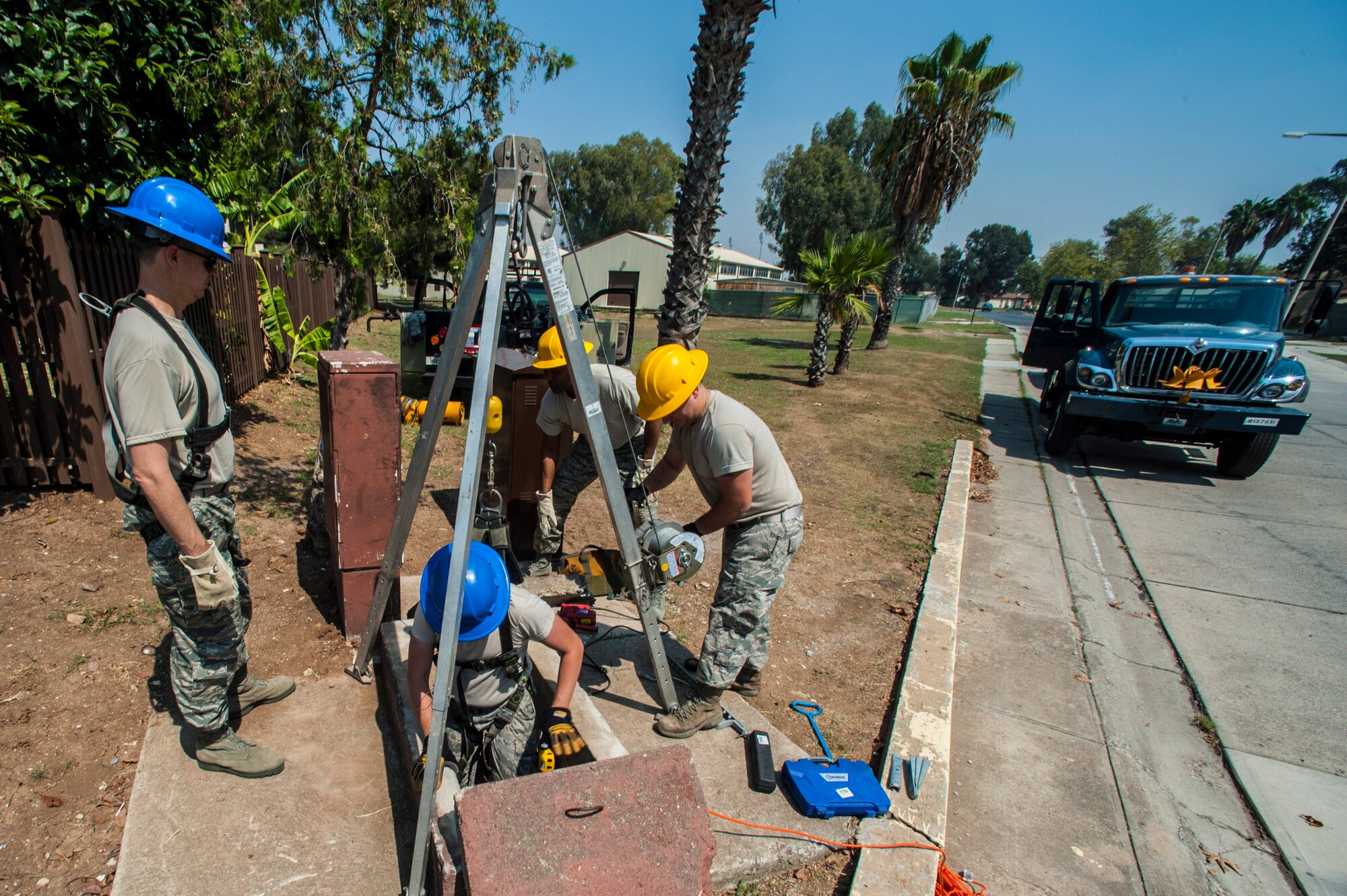 Airmen assigned to the 39th Communications Squadron explain their daily duties to Col. Craig Wills, 39th Air Base Wing commander and Chief Master Sgt. Anthony Johnson, 39th ABW command chief, Aug. 29, 2013, at Incirlik Air Base, Turkey.  The 39th CS cable and antenna maintenance technicians lowered both Wills and Johnson into a manhole and gave them a preview of their daily duties. (U.S. Air Force photo by Airman 1st Class Nicole Sikorski/Released)