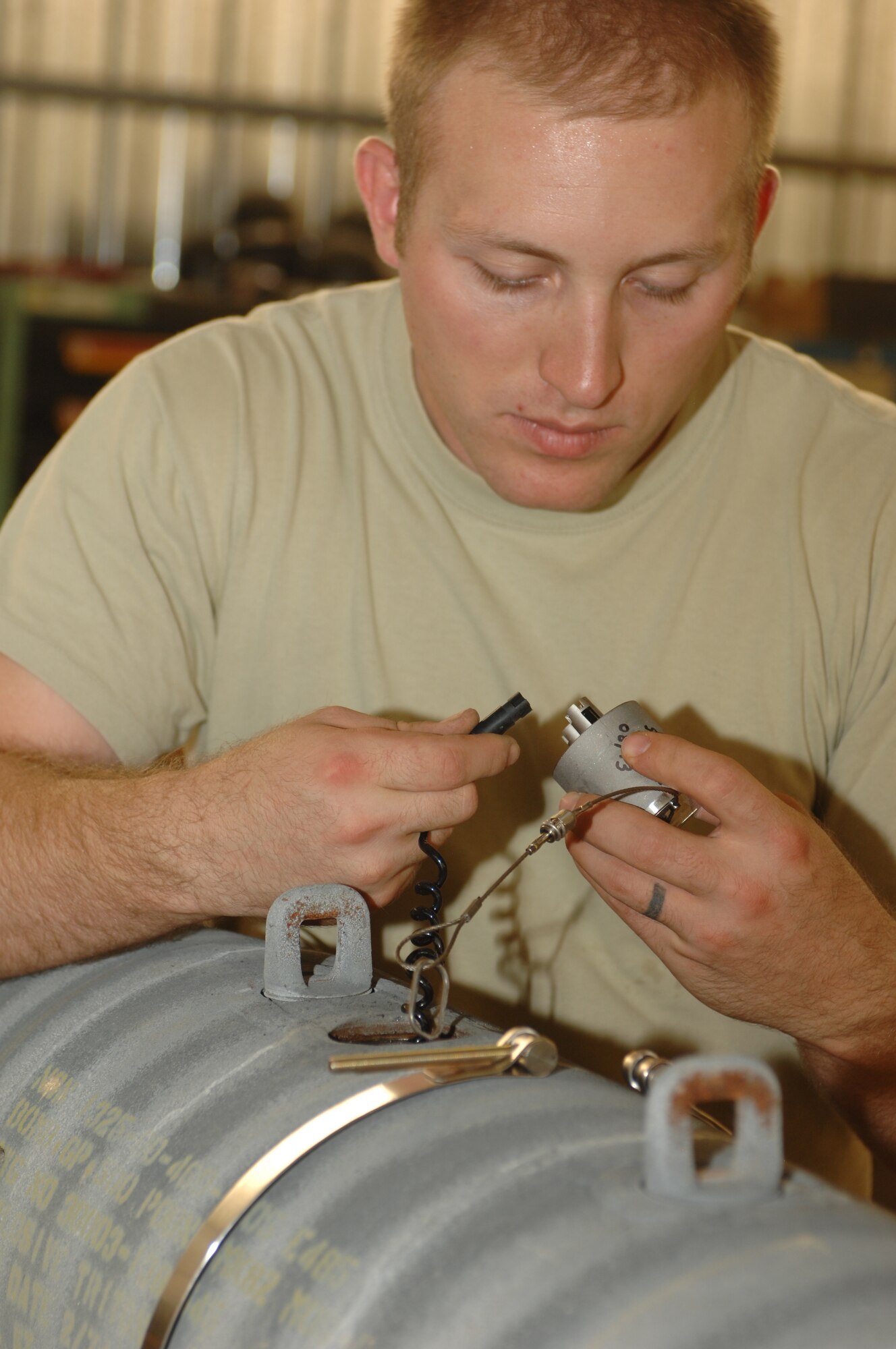 Staff Sgt. Daniel Chapman 451st Expeditionary Maintenance Squadron munitions crew chief assembles parts for a Guided Bomb Unit-54 at Kandahar Airfield, Afghanistan, Aug. 16, 2013. Airmen frequently refer to the technical order when building munitions since precise placement of the different components ensures the weapon will work correctly. Chapman is deployed from Spangdahlem Air Base, Germany, and is a native of Marion, Ill. (U.S. Air Force photo/Senior Airman Jack Sanders)
