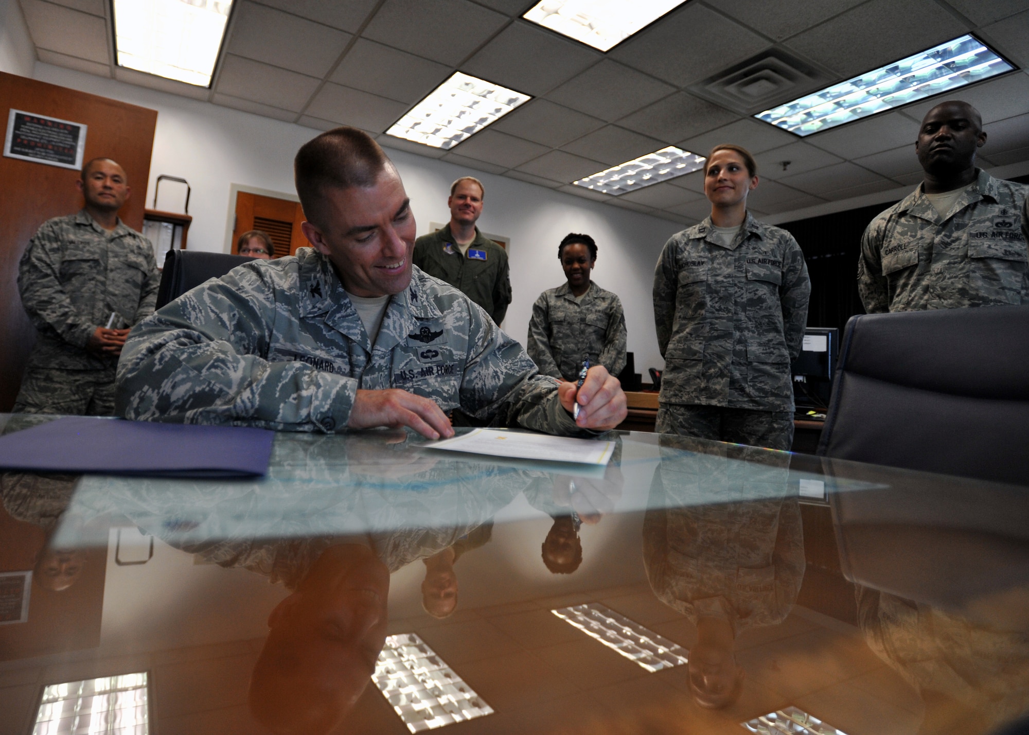 Col. Brook Leonard, 51st Fighter Wing commander, signs a Suicide Prevention Month Proclamation at Osan Air Base, Republic of Korea, Aug. 4, 2013. September is National Suicide Prevention Month, which aims to remind all service members and their families that there are multiple resources available to them if they ever have thoughts of suicide. (U.S. Air Force photo/Senior Airman Siuta B. Ika)