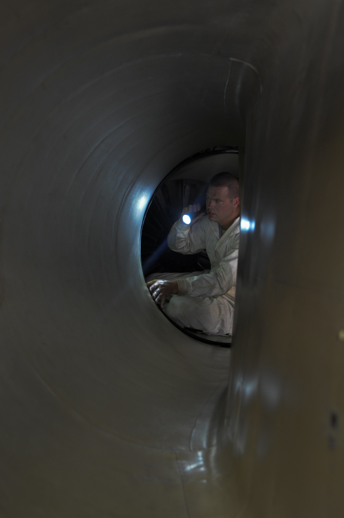 U.S. Air Force Staff. Sgt. Michael West, 380th Expeditionary Aircraft Maintenance Squadron U-2 Aircraft Maintenance Unit crew chief, checks the engine intake of a U-2 Dragon Lady for any inconstancies during a post flight check at an undisclosed location in Southwest Asia Aug. 27, 2013. In the post-flight inspection process of a U-2, crew chiefs are required to check the structure of the aircraft including getting in the engine intake. West calls Lewisburg, Ohio, home and is deployed from Beale Air Force Base, Calif. (U.S. Air Force photo by Staff Sgt. Jacob Morgan)