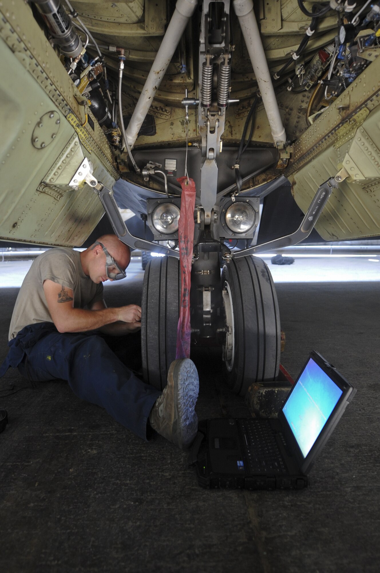 U.S. Air Force Airman 1st Class Andrew Ross, 380th Expeditionary Aircraft Maintenance Squadron U-2 Aircraft Maintenance Unit crew chief, fixes the wheel on the front landing gear of a U-2 Dragon Lady at an undisclosed location in Southwest Asia Aug. 27, 2013. The U-2 has a bicycle landing gear, meaning it only has two landing surfaces; one directly in front of the other. Ross calls Dora, Mo., home and is deployed from Beale Air Force Base, Calif. (U.S. Air Force photo by Staff Sgt. Jacob Morgan)
