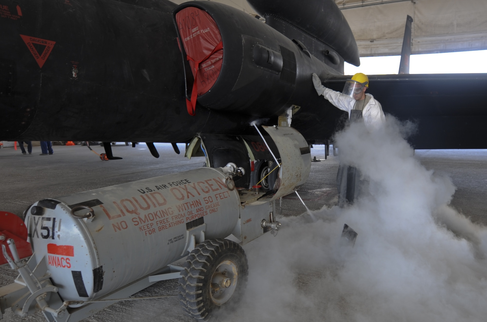 U.S. Air Force Airman 1st Class Andrew Ross, 380th Expeditionary Aircraft Maintenance Squadron U-2 Aircraft Maintenance Unit crew chief, services the liquid oxygen supply of a U-2 Dragon Lady at an undisclosed location in Southwest Asia Aug. 27, 2013. Ross calls Dora, Mo., home and is deployed from Beale Air Force Base, Calif. (U.S. Air Force photo by Staff Sgt. Jacob Morgan)