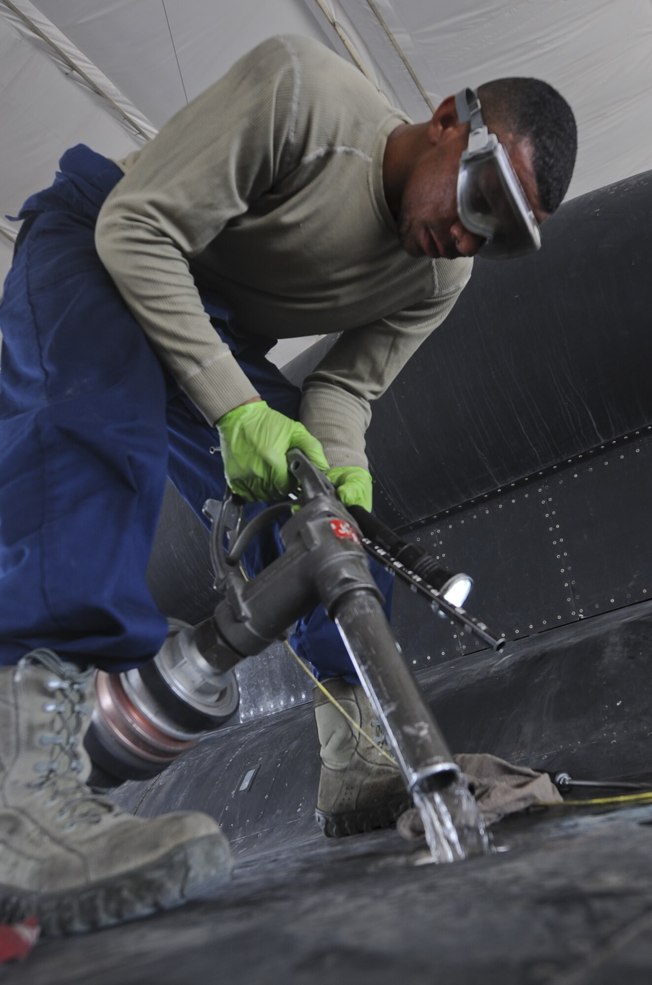 U.S. Air Force Airman 1st Class Wilbert Coleman, 380th Expeditionary Aircraft Maintenance Squadron U-2 Aircraft Maintenance Unit crew chief, fills a U-2 Dragon Lady with fuel at an undisclosed location in Southwest Asia Aug. 27, 2013. Coleman is required to fill each tank separately after the aircraft lands.  Coleman call San Antonio, Texas, home and is deployed from Beale Air Force Base, Calif. (U.S. Air Force photo by Staff Sgt. Jacob Morgan)