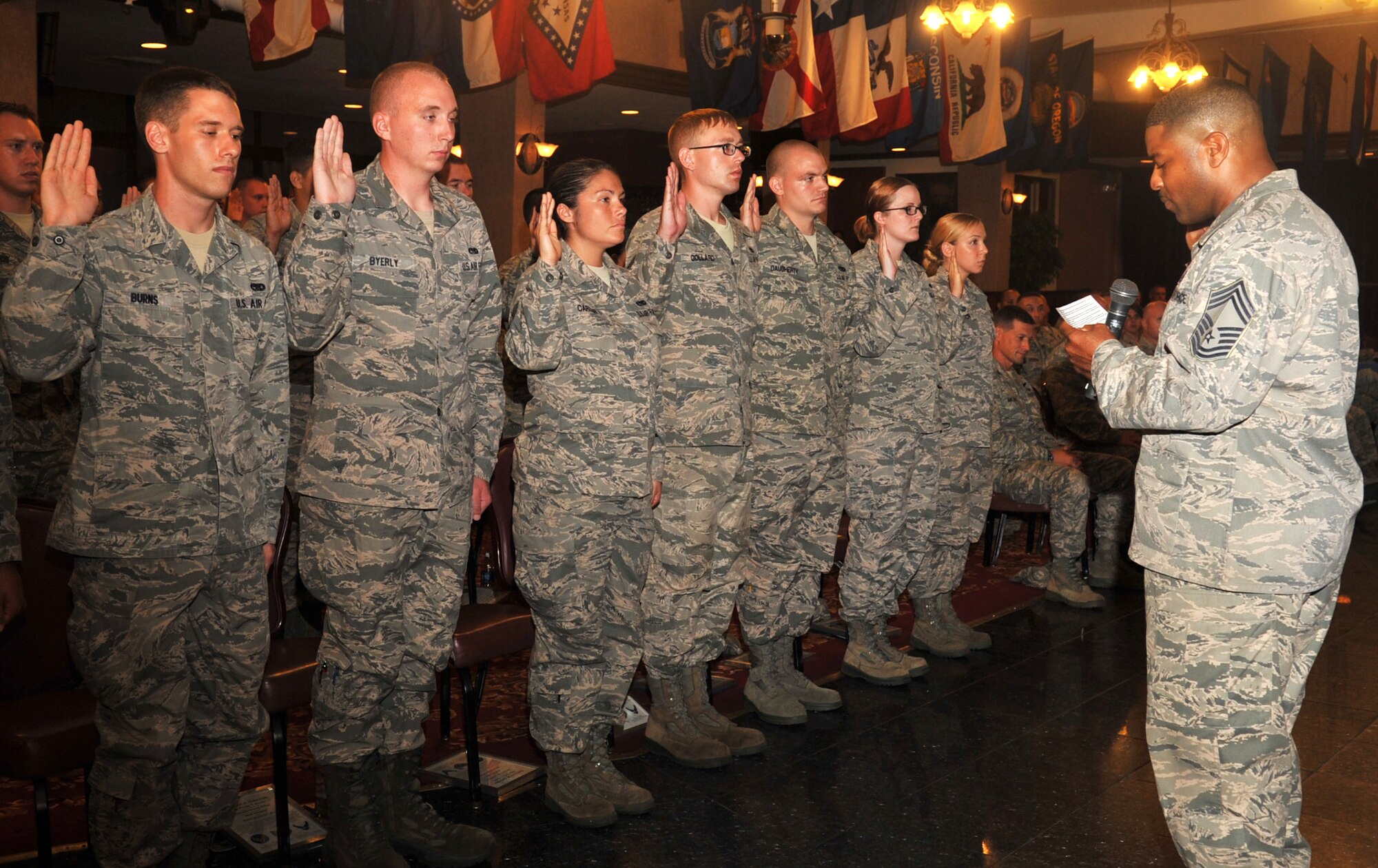 U.S. Air Force Chief Master Sgt. Phillip Easton, 18th Mission Support Group superintendent, inducts newly promoted staff sergeants during a quarterly NCO induction ceremony at the Rocker NCO Club on Kadena Air Base, Japan, Sept. 4, 2013. The ceremony celebrates and recognizes those who have recently put on the rank of staff sergeant and have reached the status of NCO. (U.S. Air Force photo by Naoto Anazawa)