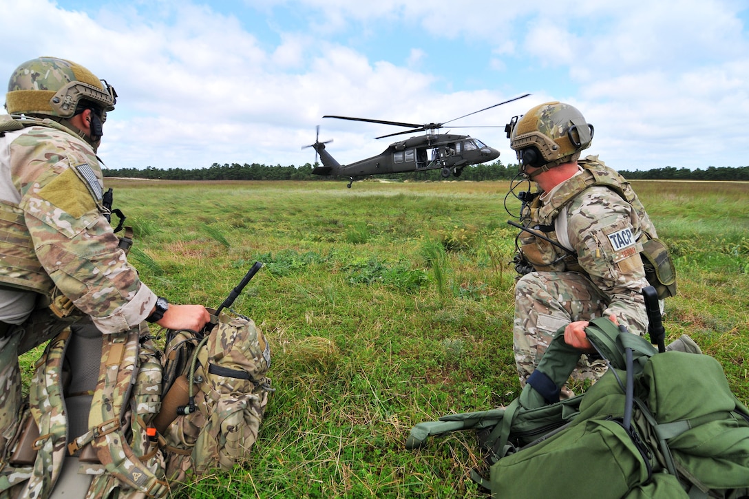 Air Force Staff Sgt. Kane Lawlor, left, and Airman 1st Class Joshua Darins, right, prepare to board a UH-60 Black Hawk helicopter during training at Warren Grove Gunnery Range in Ocean County, N.J., Aug. 29, 2013. Lawlor and Darins, tactical air control party airmen, are assigned to the New Jersey Air National Guard's 227th Air Support Operations Squadron, 177th Fighter Wing.