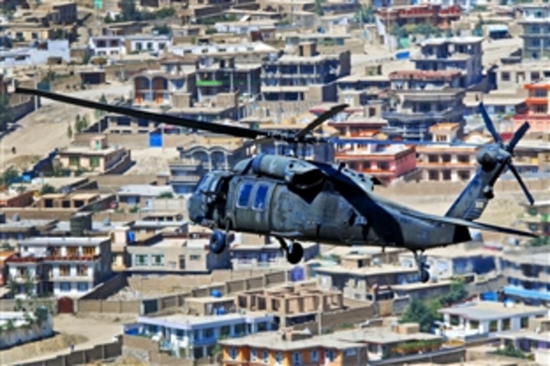 U.S. Army 1st Lt. Chuck Nadd, U.S. Army Chief Warrant Officer 4 Darren Dreher, U.S. Army Staff Sgt. Bruce Kleckner and U.S. Army Sgt. Jay Herring fly a UH-60L Black Hawk helicopter to move personnal over Kabul, Afghanistan, Sept. 4, 2013. Nadd and Dreher, pilots, and Kleckner and Herring, crew chiefs, are assigned to Company A, 2nd Battalion General Support, 104th Aviation Regiment.