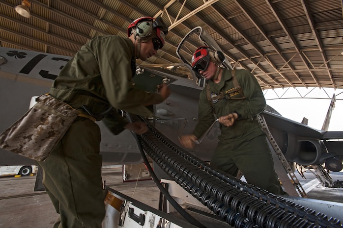Lance Cpl. Ryan Schladitz, left, instructs Lance Cpl. Michael Smith, both aviation ordnancemen with Marine All-Weather Fighter Attack Squadron 242, on the proper way to load 20mm training practice rounds into an F/A-18C Hornet during Exercise Southern Frontier Aug. 8, 2013, at Royal Australian Air Force Base Tindal, Australia. Southern Frontier is conducted annually to enhance flight operations and maintain proficiency as well as maintain interoperability between allied and partner nations.