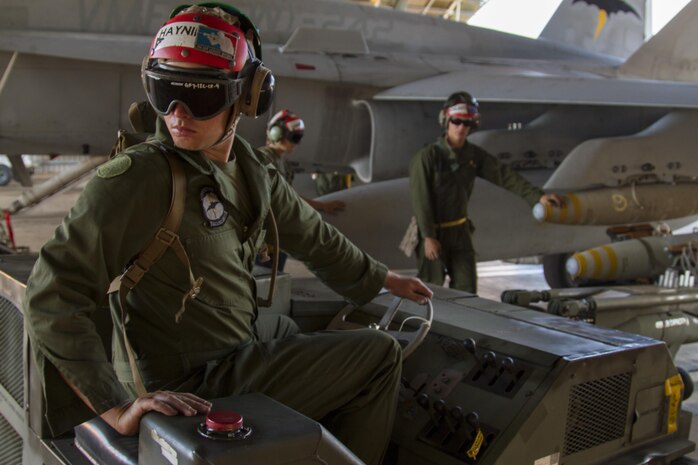 Lance Cpl. Dallin Haynie, an aviation ordnanceman with Marine All-Weather Fighter Attack Squadron 242, reverses a short airfield tactical support loader after loading ordnance on an F/A-18C Hornet, during Exercise Southern Frontier at Royal Australian Air Force Base Tindal, Australia, Aug. 8, 2013. 