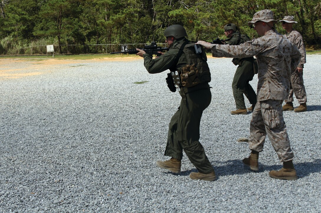 Staff Sgt. Jordan G. Hardy, front left, and Cpl. Troy A. Biggs, front right, begin a movement-while-firing drill Aug. 27 at the battle-sight zero range on Camp Schwab. The drill was designed to improve the basic skills of the Special Reaction Team Marines while improving unit cohesion. Hardy is the SRT platoon commander, and Biggs is an SRT member. SRT is part of the Provost Marshal’s Office, Marine Corps Base Camp Smedley D. Butler, Marine Corps Installations Pacific.