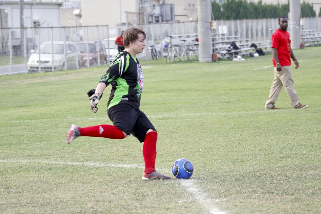 Josh Hess, Matthew C. Perry student and Gaijins goal keeper, prepares to kick the ball during an Intramural soccer game held at Penny Lake Field at Marine Corps Air Station Iwakuni, Japan, August 5, 2013. The Gaijins team is comprised of M. C. Perry students and alumni, all of which went up against a team of Marines. Prior to this game, the Gaijins won two games while the Dragons had one win and two losses.
