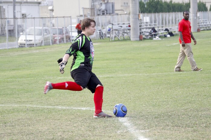 Josh Hess, Matthew C. Perry student and Gaijins goal keeper, prepares to kick the ball during an Intramural soccer game held at Penny Lake Field at Marine Corps Air Station Iwakuni, Japan, August 5, 2013. The Gaijins team is comprised of M. C. Perry students and alumni, all of which went up against a team of Marines. Prior to this game, the Gaijins won two games while the Dragons had one win and two losses.