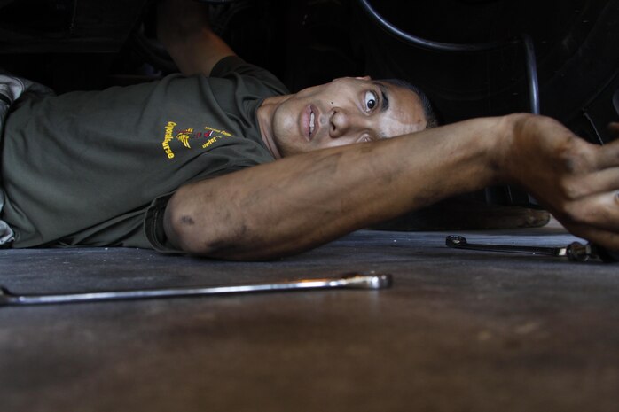 Cpl. Tyler Alcisto, Marine Wing Support Squadron 171 motor transportation mechanic, works on a dead-lined 7-ton truck at the MWSS-171 motot-T warehouse at Marine Corps Air Station Iwakuni, Japan, Aug. 21, 2013. While the majority of the unit is away, motor-T mechanics repair the vehicles for operational use once the Marines return.