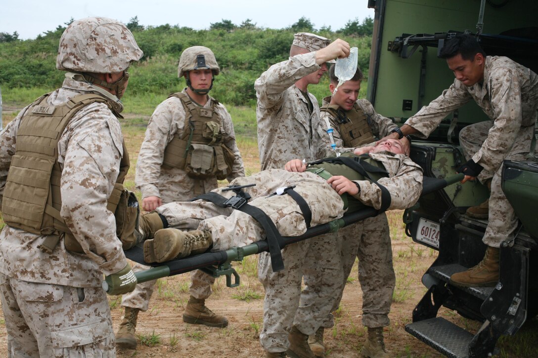 Marines and sailors prepare a mock casualty for transport during medical evacuation training Aug. 31 at the Ojojihara Maneuver Area. The training was in preparation for the live-fire artillery scheduled to take place during Artillery Relocation Training Program 13-2. The Marines and sailors are with 1st Battalion, 12th Marine Regiment, currently assigned to 3rd Battion, 12th Marines, 3rd Marine Division, III Marine Expeditionary Force, under the unit deployment program.