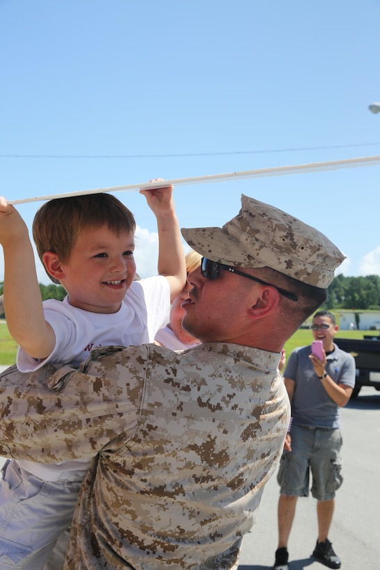 Cpl. Tyson Donaldson embraces his 3-year-old son after returning from a five-month deployment to Spain Friday. While deployed Donaldson, a communications technician with Marine Air Control Squadron 2, and seven other Marines attached to Marine Medium Tiltrotor Squadron 365 served as a Marine air traffic control mobile team.