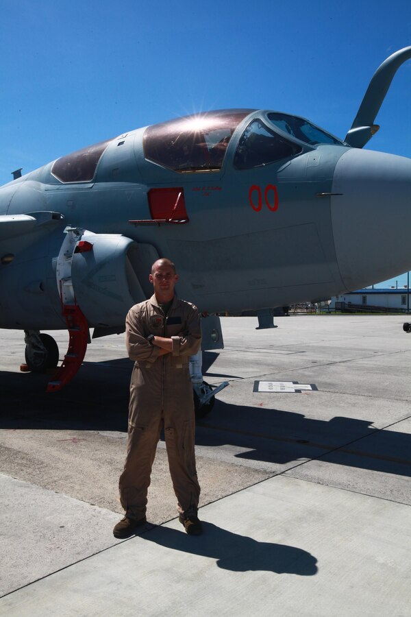 Cpl. Joshua B. Dyer stands in front of an EA-6 Prowler on the flightline Aug. 26. Dyer is an EA-6 Prowler powerline mechanic with Marine Tactical Electronic Warfare Training Squadron 1. As a powerline mechanic, Dyer inspects and maintains the engines of the EA-6 Prowler as well as performs duties relating to flightline operations.