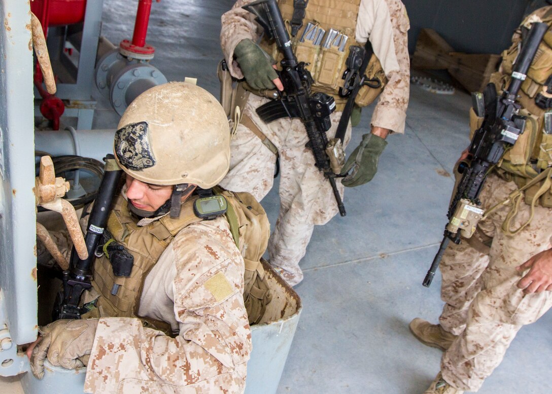 A U.S. Marine assigned to Force Reconnaissance Platoon, Maritime Raid Force, 26th Marine Expeditionary Unit (MEU), descends a ladder to clear the engine room of a vessel during Maritime Interdiction Operations (MIO) training in the U.S. 5th Fleet area of responsibility, Aug. 28, 2013. The 26th MEU is a Marine Air-Ground Task Force forward-deployed to the U.S. 5th Fleet area of responsibility aboard the Kearsarge Amphibious Ready Group serving as a sea-based, expeditionary crisis response force capable of conducting amphibious operations across the full range of military operations. (U.S. Marine Corps photo by Sgt. Christopher Q. Stone, 26th MEU Combat Camera/Released)