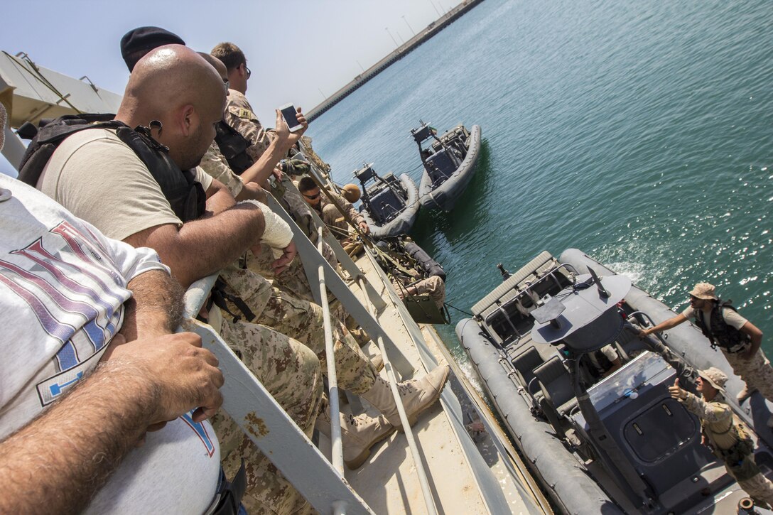 A U.S. Marine and a Special Amphibious Reconnaissance Corpsman assigned to Force Reconnaissance Platoon, Maritime Raid Force, 26th Marine Expeditionary Unit (MEU), demonstrate to foreign Marines how lower a casualty with a SKEDCO Sked System to a rigid hull inflatable boat during Maritime Interdiction Operations (MIO) training in the U.S. 5th Fleet area of responsibility, Aug. 28, 2013. The 26th MEU is a Marine Air-Ground Task Force forward-deployed to the U.S. 5th Fleet area of responsibility aboard the Kearsarge Amphibious Ready Group serving as a sea-based, expeditionary crisis response force capable of conducting amphibious operations across the full range of military operations. (U.S. Marine Corps photo by Sgt. Christopher Q. Stone, 26th MEU Combat Camera/Released)