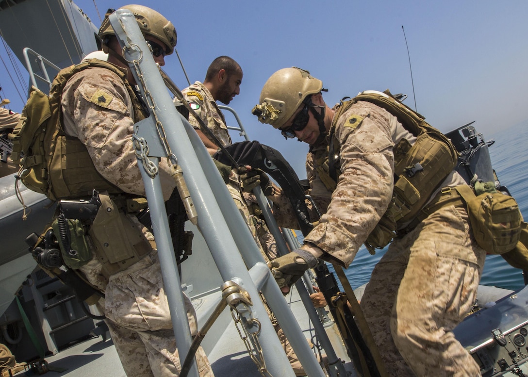 Foreign Marines and U.S. Marines assigned to Force Reconnaissance Platoon, Maritime Raid Force, 26th Marine Expeditionary Unit (MEU), board a vessel during simulated Maritime Interdiction Operations (MIO) training in the U.S. 5th Fleet area of responsibility, Aug. 29, 2013. The 26th MEU is a Marine Air-Ground Task Force forward-deployed to the U.S. 5th Fleet area of responsibility aboard the Kearsarge Amphibious Ready Group serving as a sea-based, expeditionary crisis response force capable of conducting amphibious operations across the full range of military operations. (U.S. Marine Corps photo by Sgt. Christopher Q. Stone, 26th MEU Combat Camera/Released)