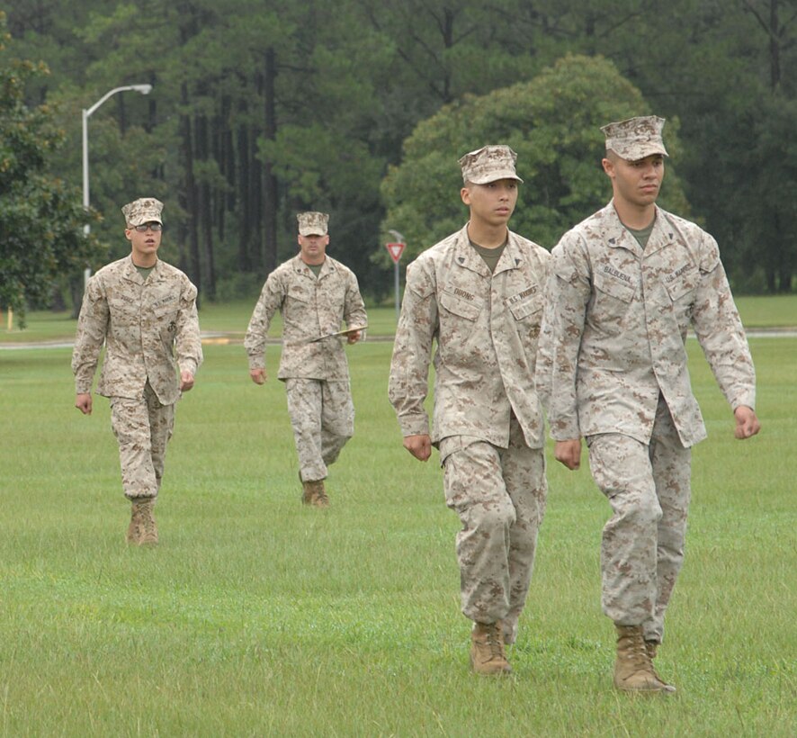 Lance Cpl. Gregory Perez calls out drill commands to his platoon, during the meritorious corporal promotion competition on Schmid Field, in front of Coffman Hall, Building 3500, recently.