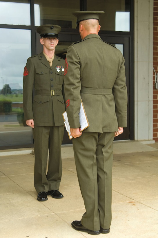 Lance Cpl. James Huddleston endures intense questioning and an uniform inspection by Staff Sgt. Daniel Walters as part of his competition for the recent meritorious corporal promotion board held here.