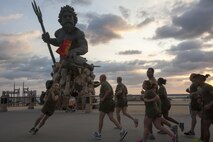 Sgt. Nicholas Ross, a data network specialist, Headquarters and Service Battalion, U.S. Marine Corps Forces Command, runs the H&S Bn. guidon around the formation in a gratuitous display of motivation Sept. 6. Col. Paul Ryan, commanding officer, Headquarters and Service Battalion, U.S. Marine Corps Forces Command, lead the Marines on the formation run to increase the Marines' physical fitness while building unit morale and esprit de corps.