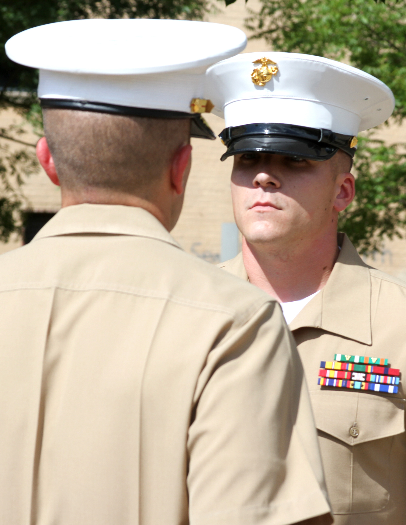 Sergeant Dallas Allen , a recruiter with Recruiting Substation Oklahoma City South, Recruiting Station Oklahoma City, stands toe to toe with Maj. R.H. Robinson III, Commanding Officer, Recruiting Station Oklahoma City during a Bronze Star ceremony at the Oklahoma City National Memorial Aug. 23.   Allen was awarded the Bronze Star with the combat distinguishing “V” device, for valor for his extraordinary actions May 2012, while serving as squad leader with 2nd Battalion, 6th Marine in Helmand Province, Afganistan. 2/6 was partnered with the Afghan National Army in Helmand Province in May 2012, when a rogue Afghan soldier opened fire on Allen’s squad. As the only member of the patrol unharmed during the barrage, Allen located the enemies’ position and killed him. He later controlled the situation by sending medical evacuation requests, establishing security and aiding in casualty care. The 26-year old Allen is from Gloucester, Va. (Marine Corps Photo By Sgt. Lucas Vega/ RELEASED)