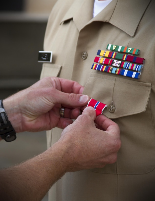 Sergeant Dallas Allen , a recruiter with Recruiting Substation Oklahoma City South, Recruiting Station Oklahoma City, is pinned the Bronze Star at the Oklahoma City National Memorial Aug. 23. Allen, was awarded the Bronze Star with the combat distinguishing “V” device, for valor for his extraordinary actions while partnered with the Afghan National Army in Helmand Province, when a rogue Afghan soldier opened fire on Allen’s squad. As the only member of the patrol unharmed during the barrage, Allen located the enemies’ position and killed him. He later controlled the situation by sending medical evacuation requests, establishing security and aiding in casualty care. The 26-year old Allen is from Gloucester, Va.  (Marine Corps Photo By Sgt. Lucas Vega/ RELEASED)