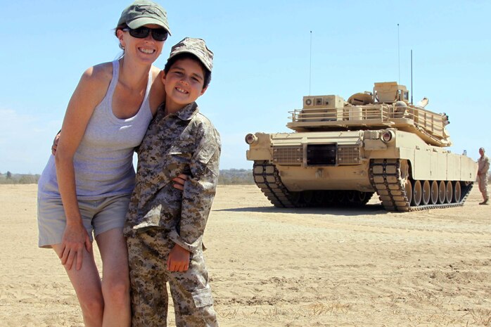 Casi Mayo and her son, Baden, hug infront of a tank Sept. 4. 7-year- old Bayden was diagnosed with Acute Lymphoblastic Leukemia December 10, 2010, his dream was to ride in a tank and Charity for Charity made that dream come true.