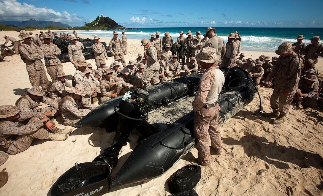 Marines with Alpha Company, Battalion Landing Team 1st Battalion, 4th Marine Regiment, 13th Marine Expeditionary Unit, give an informal period of military instruction to Marines with 1st Battalion, 3rd Marine Regiment, Aug. 30, 2013. The class went over the basics of operating F470 Zodiac Combat Rubber Raid Craft like nomenclature, sitting positions and billets on the craft. (U.S. Marine Corps photo by Cpl. Matthew Callahan)