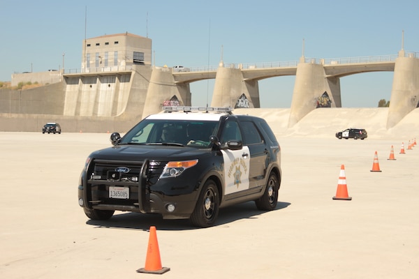 Several California highway patrolmen, trainers, and volunteers ascended on the spillway of the Sepulveda Dam to train on the use of the CHP's newest patrol car, the Ford Police Interceptor-Utility Model, during an exercise Aug. 16.