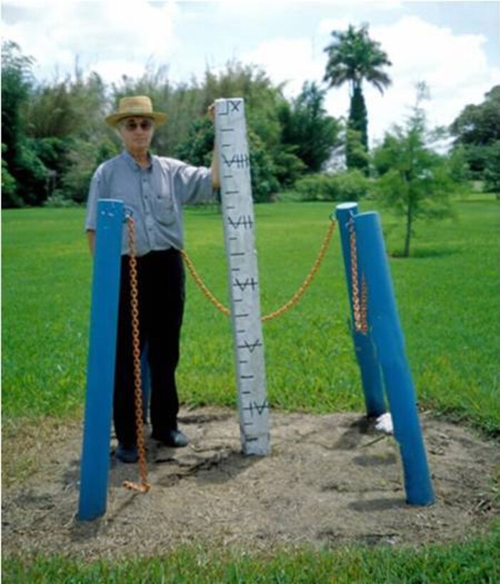 In 1924, this nine-foot concrete post was driven to bedrock at the Everglades Research and Education Center in Belle Glade. This photo shows about 69 inches of soil subsidence had already occurred in the Everglades Agricultural Area by 1998, an average of about 0.93 inches per year. 