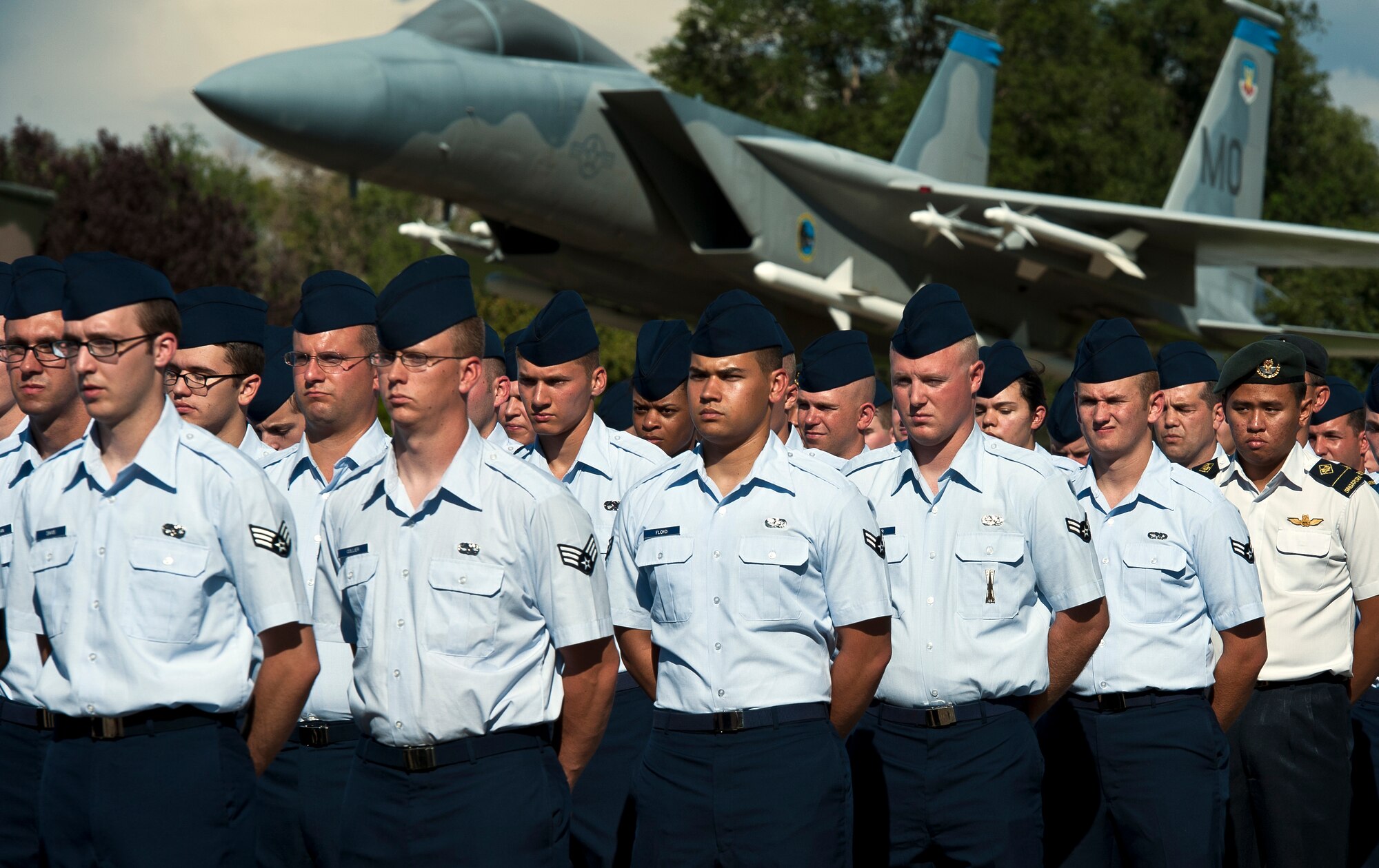 U.S. and Singaporean Airmen from the 366th Operations Group stand at parade rest and reflect as Col. Christopher Short, 366th Fighter Wing commander, reads the history of the Retreat Ceremony at Mountain Home Air Force Base, Idaho, Sept. 5, 2013. Airmen from both nations fly and maintain versions of the F-15 Eagle airframe at the base. (U.S. Air Force photo by Master Sgt. Kevin Wallace/RELEASED)