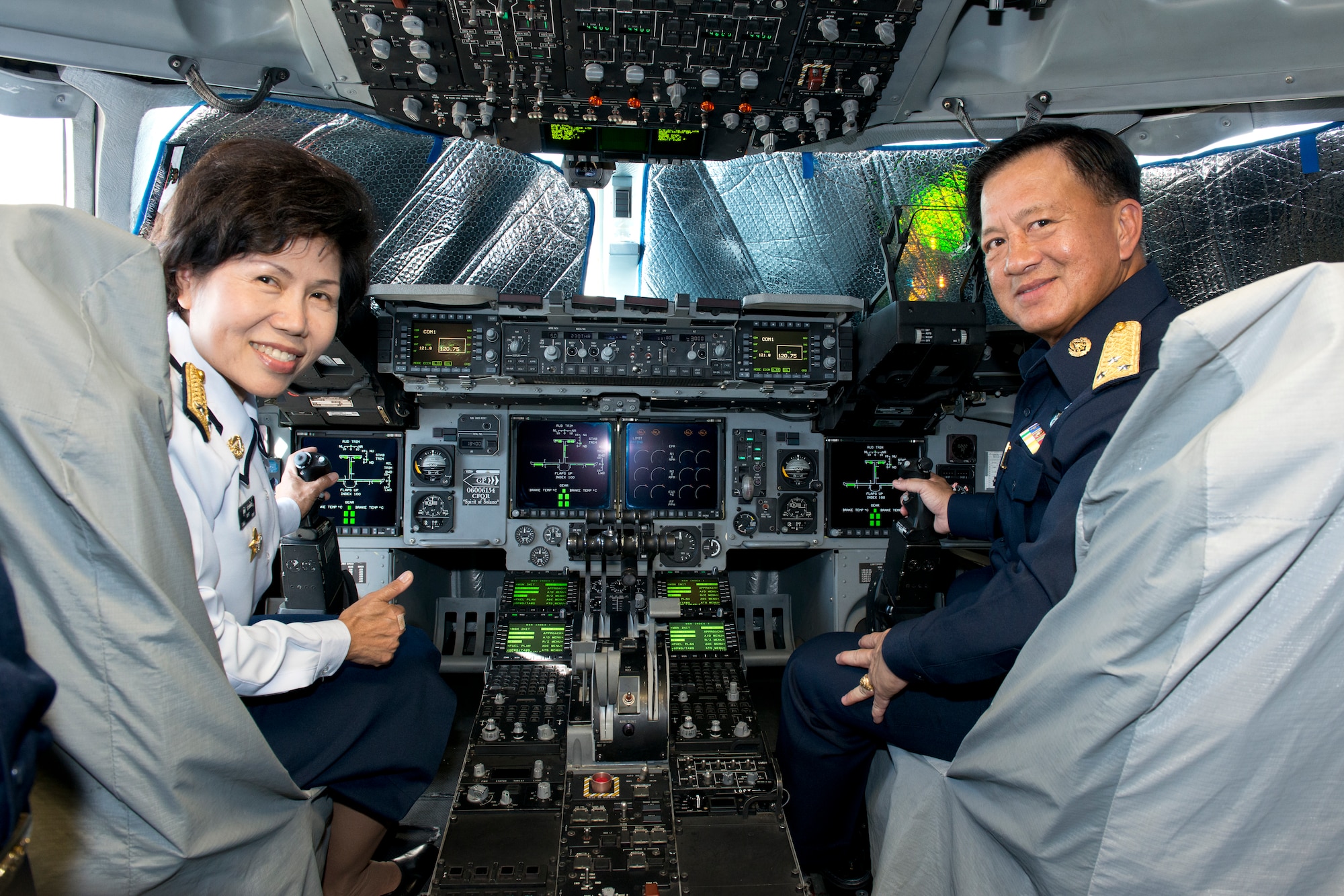 Air Vice Marshal Supit Prasopsil, left, Royal Thai Air Force, and Air Marshal Chuphan Chansmorn, Royal Thai Air Force surgeon general, pose for a photo on the flight deck of a C-17 Globemaster III Aug. 26 during their tour of Travis. The Thai Air Force visited Travis to compare U.S. Air Force medical practices and processes at David Grant USAF Medical Center to those used in the Royal Thai Air Force. (U.S. Air Force photo/Senior Airman Madelyn Brown)