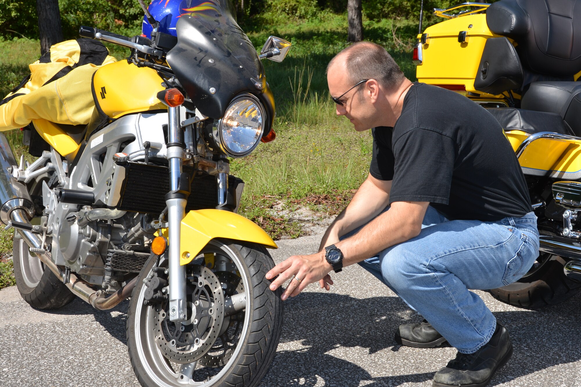 Lt. Col. Jeremy Jennes, AFNORTH Chief of Safety, checks out the tread depth on his tires prior to the “Motorcycle Mentorship Ride” on August 21. U.S. Air Force photo by Mary McHale